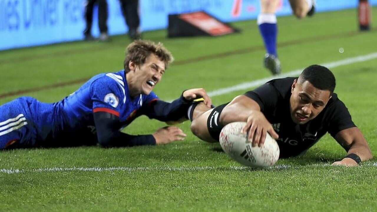 Baptiste Serin of France fails to stop Ngani Laumape of New Zealand.