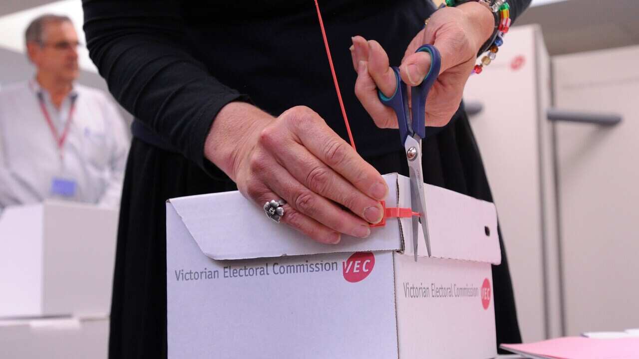 File image of an Election staff member cutting the seal of a ballot box