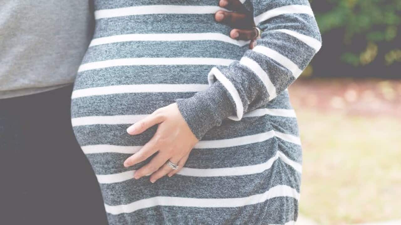 A pregnant woman.