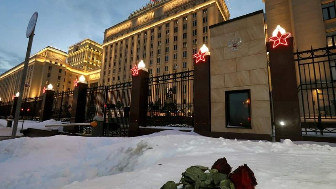 Roses lie on the snow outside the Russian Defence Ministry