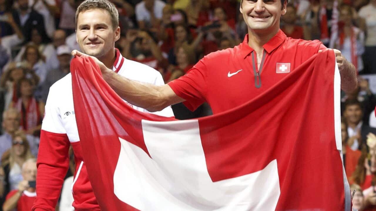 Swiss tennis players Roger Federer (R) and Marco Chiudinelli