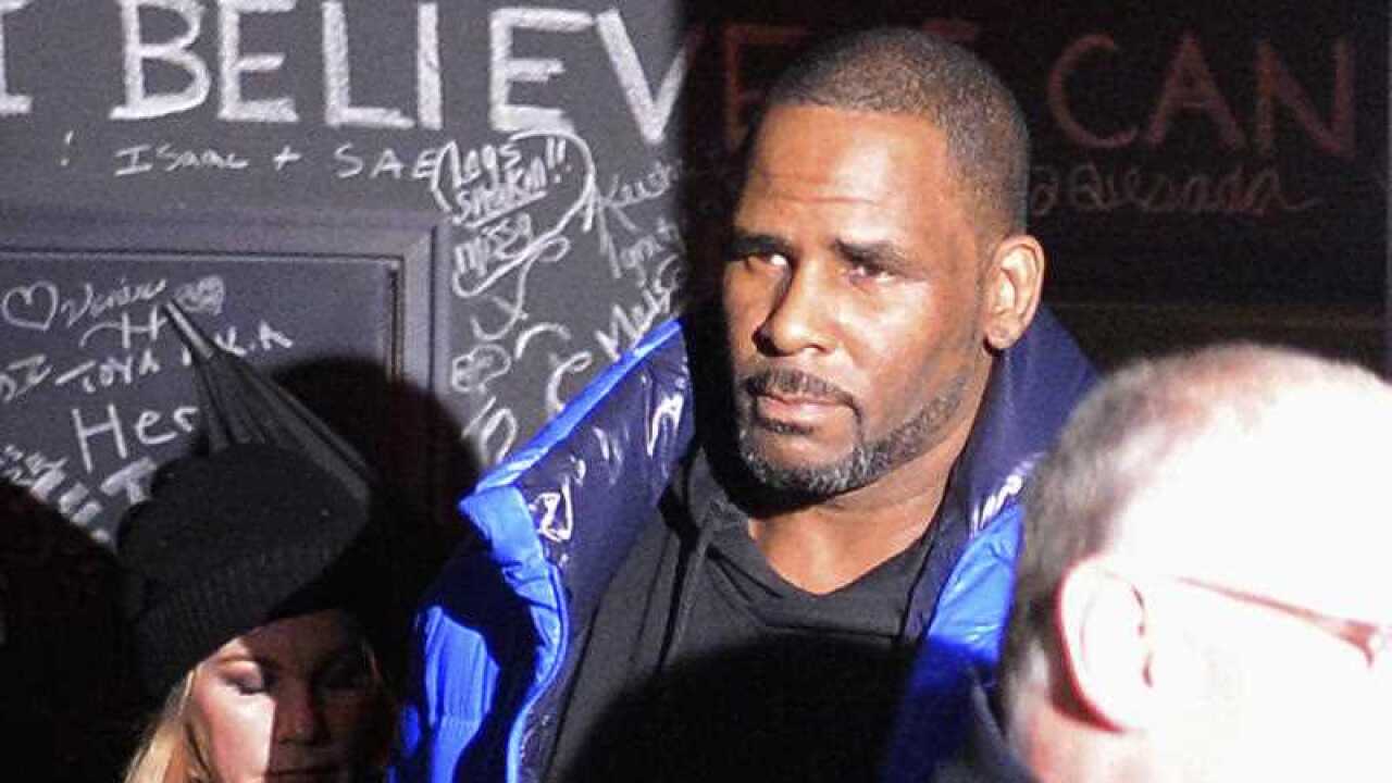 R Kelly leaves his Chicago studio on his way to surrender to police.