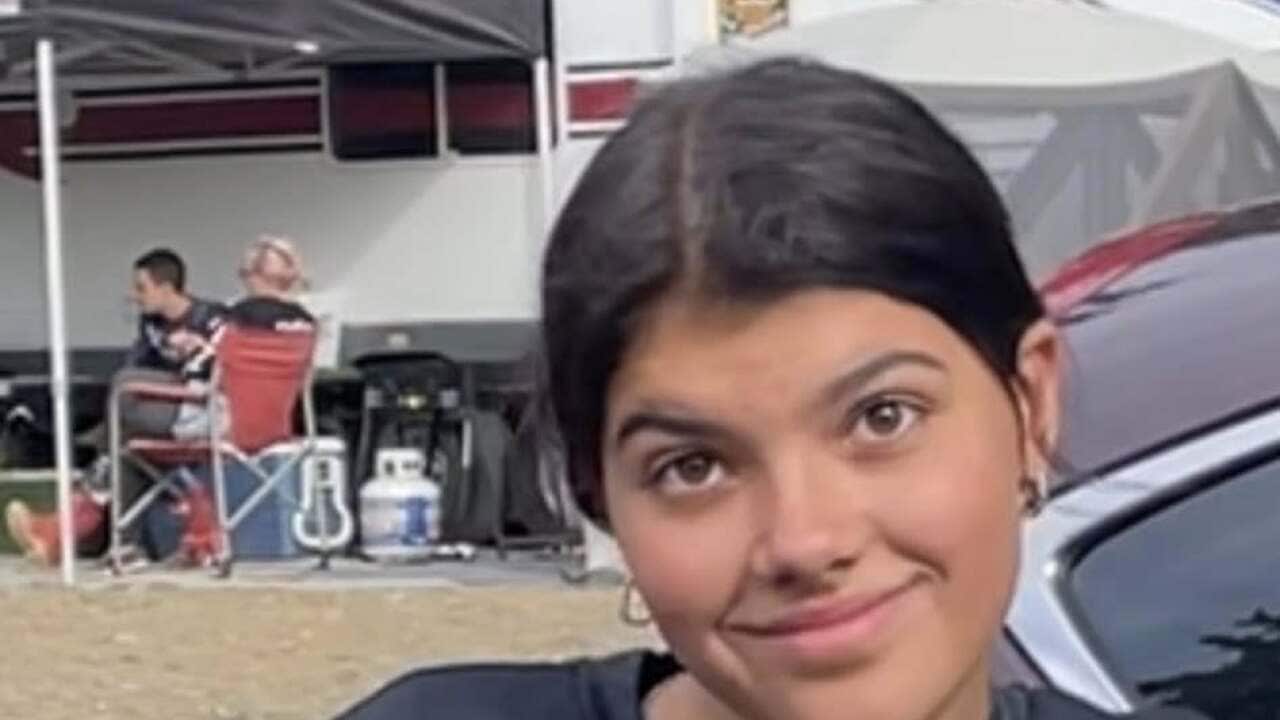 A young woman on a bike smiling at the camera