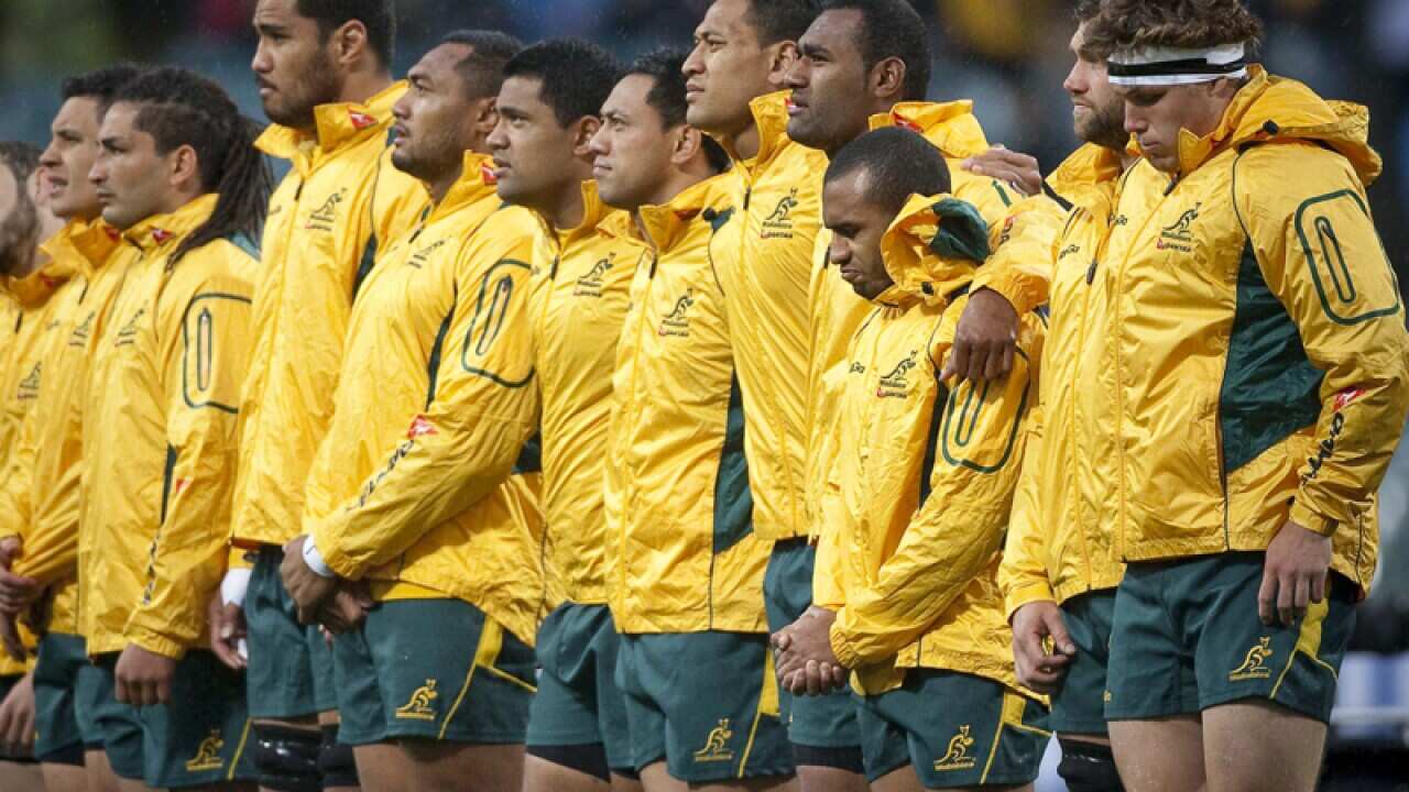 Wallabies players sing the national anthem