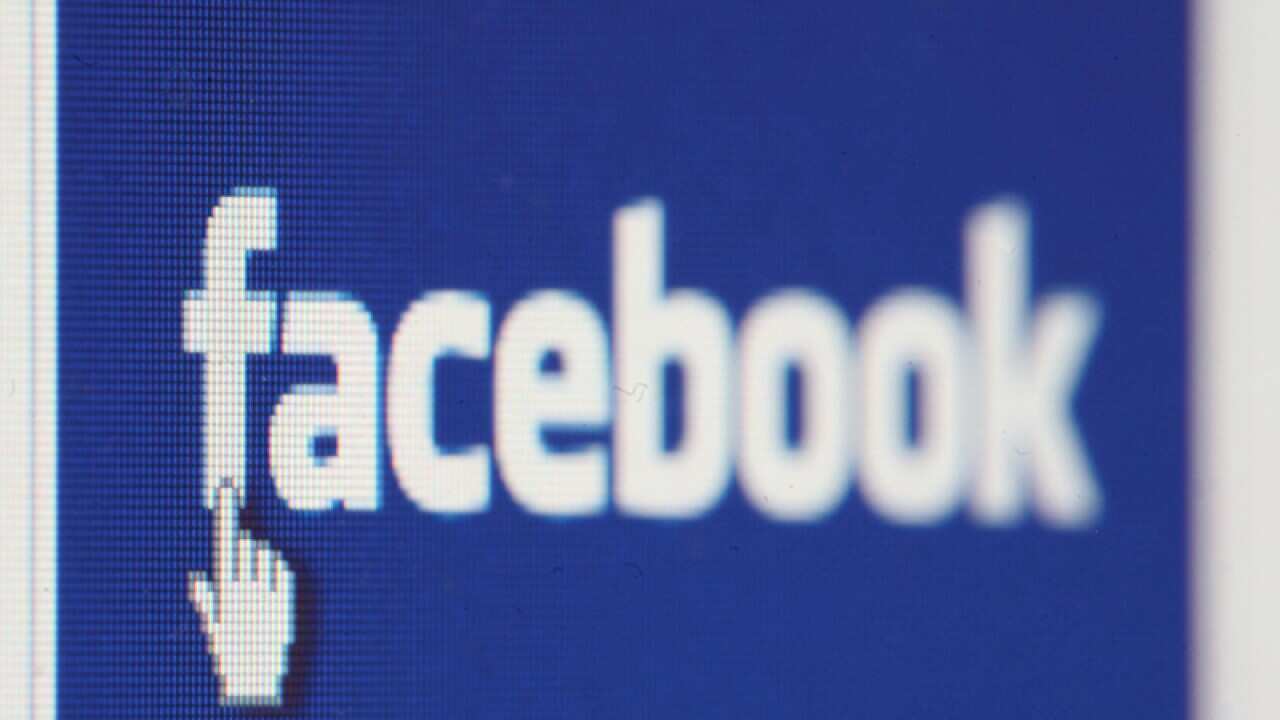 The Facebook logo displayed on a laptop