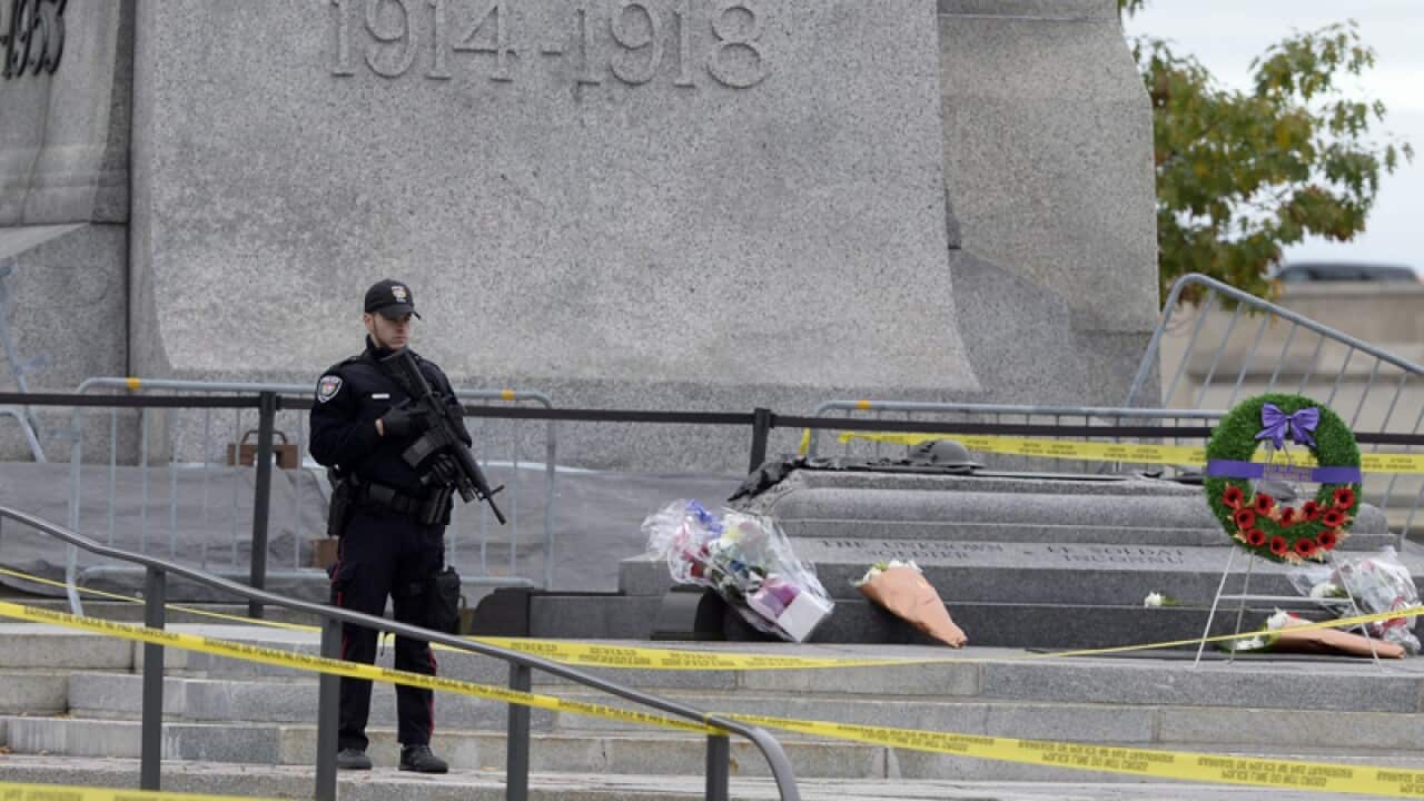 A police officer on guard outside the National War Memorial in Ottawa