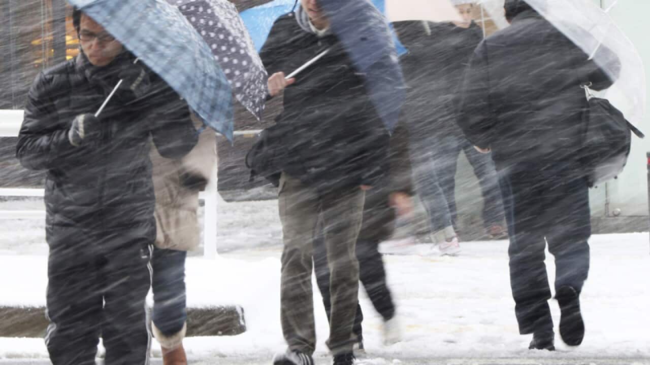 People walking in a snow storm in Japan