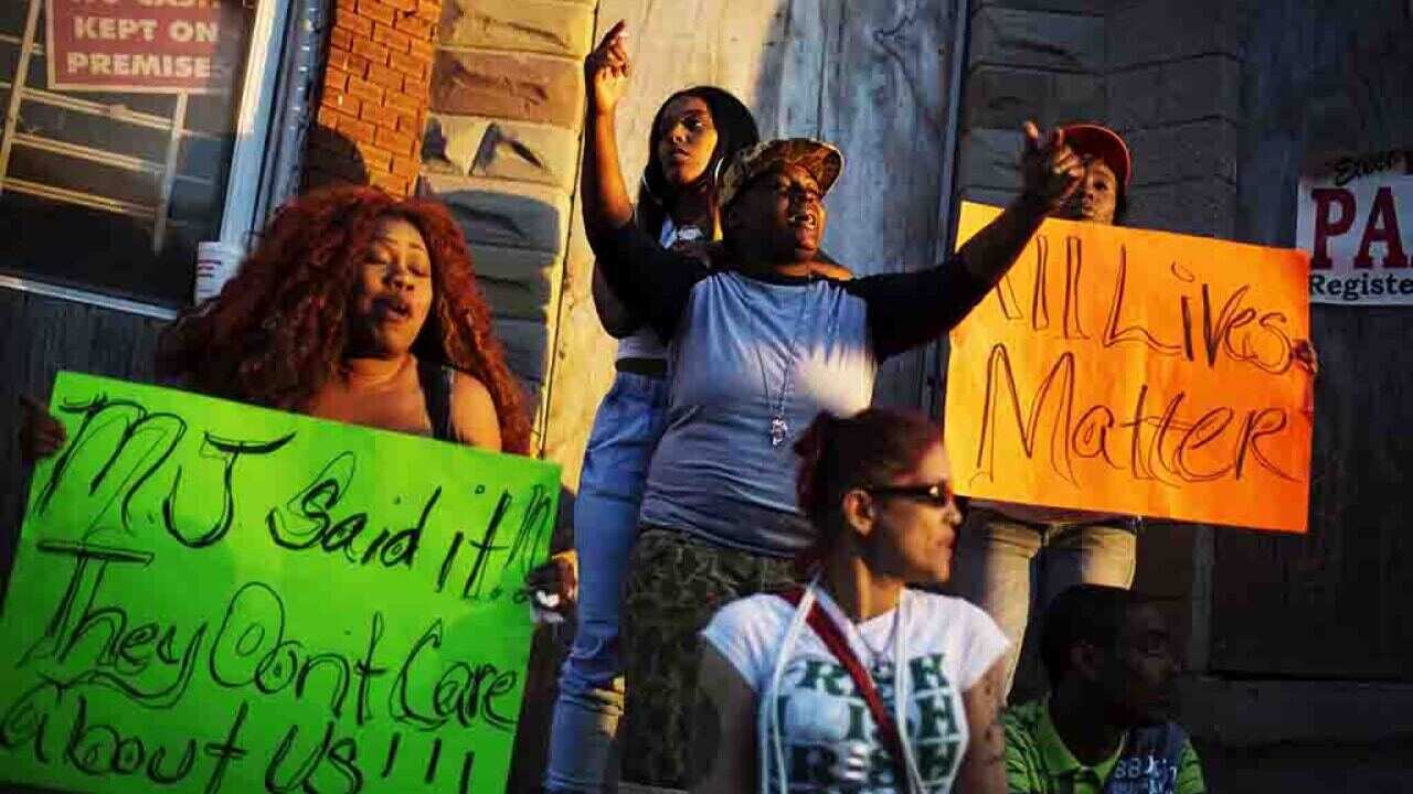 Festive Baltimore rallies in hope after police charged