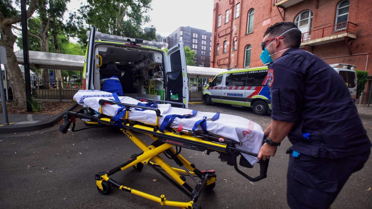 Paramedics tending to their ambulance outside St Vincent hospital in Melbourne.