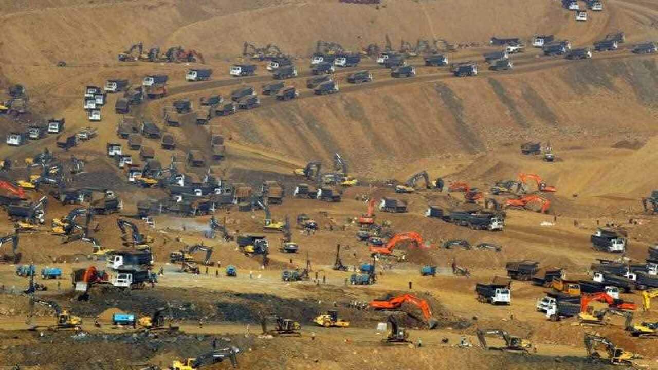 Workers use heavy earth-excavators to mine jadeite at the Hpakant jade mining area in Kachin State.
