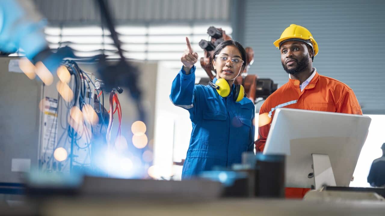 Female engineer presentation robotic welding process to her team in testing area of research and development. Production process improvement concepts.