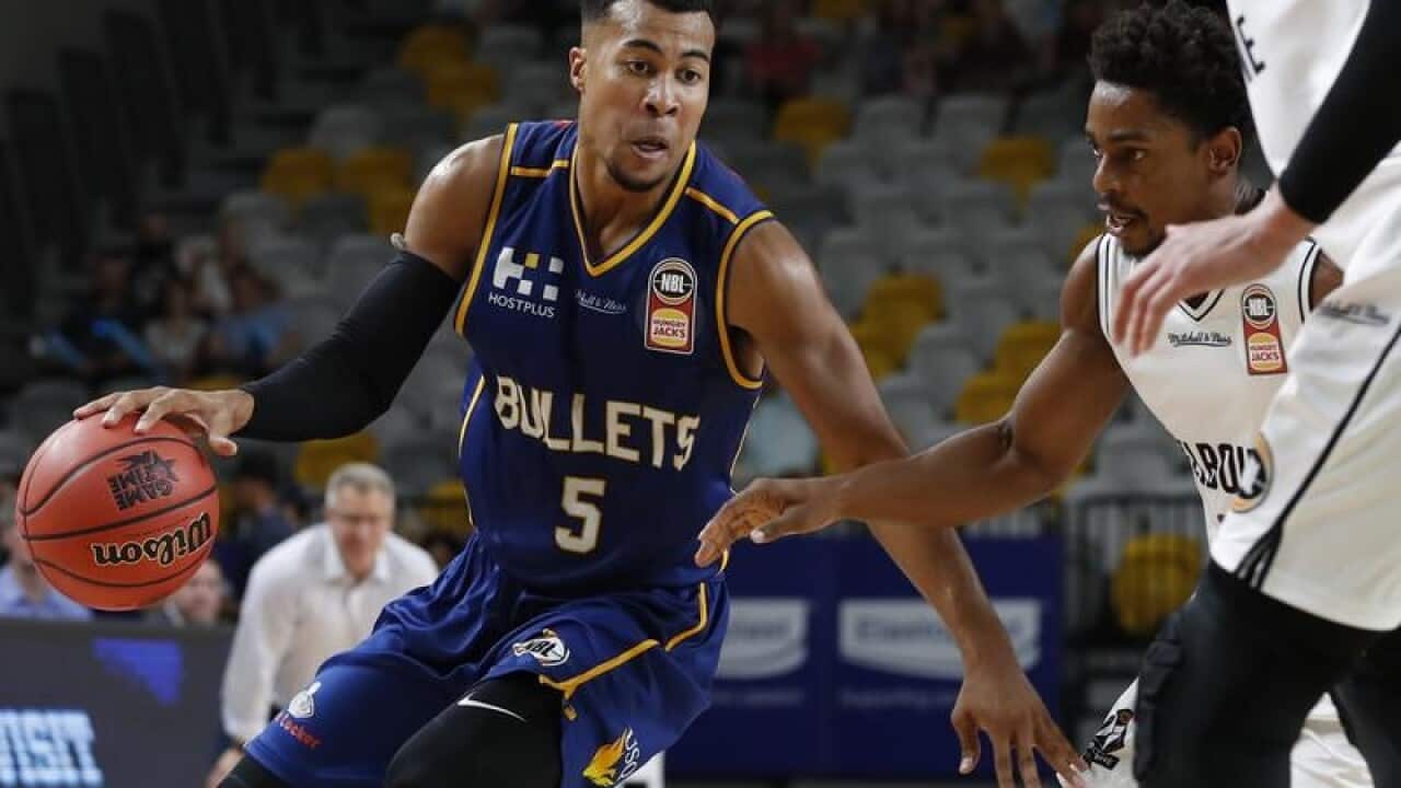 Stephen Holt of the Bullets tries to get past Casper Ware of United.