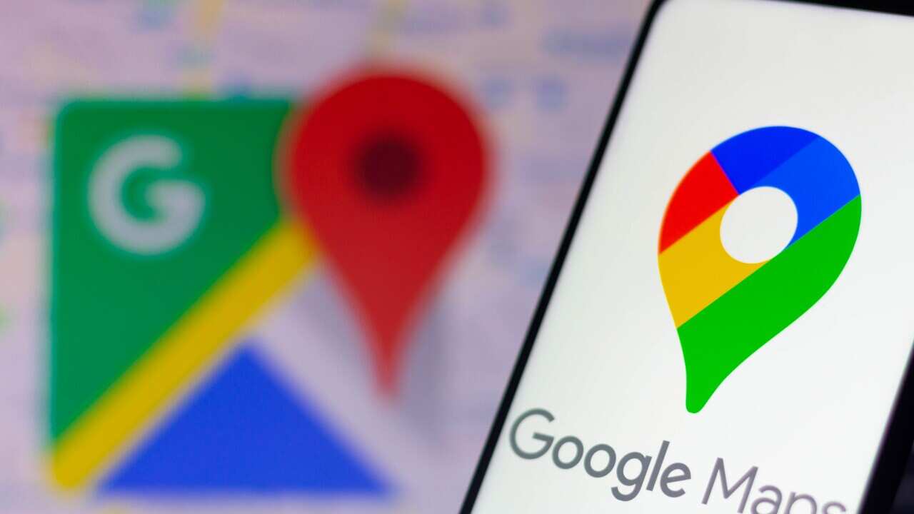 A photo illustration of Google Maps logo displayed on a smartphone and in the background.