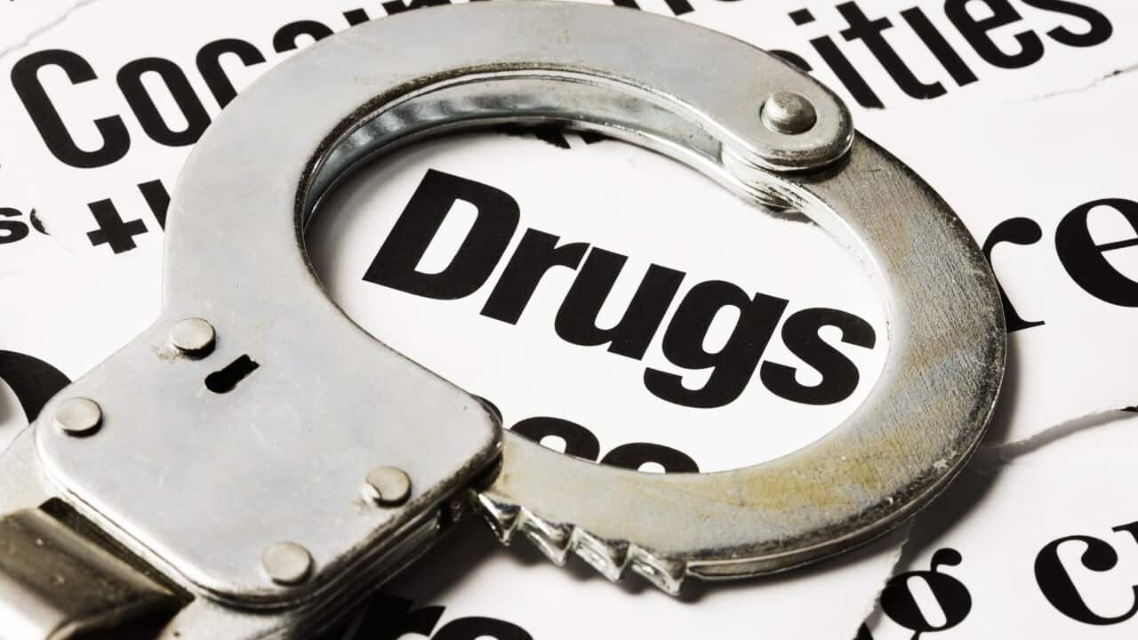 Handcuff circles 'drugs' in pile of headlines about drug crime