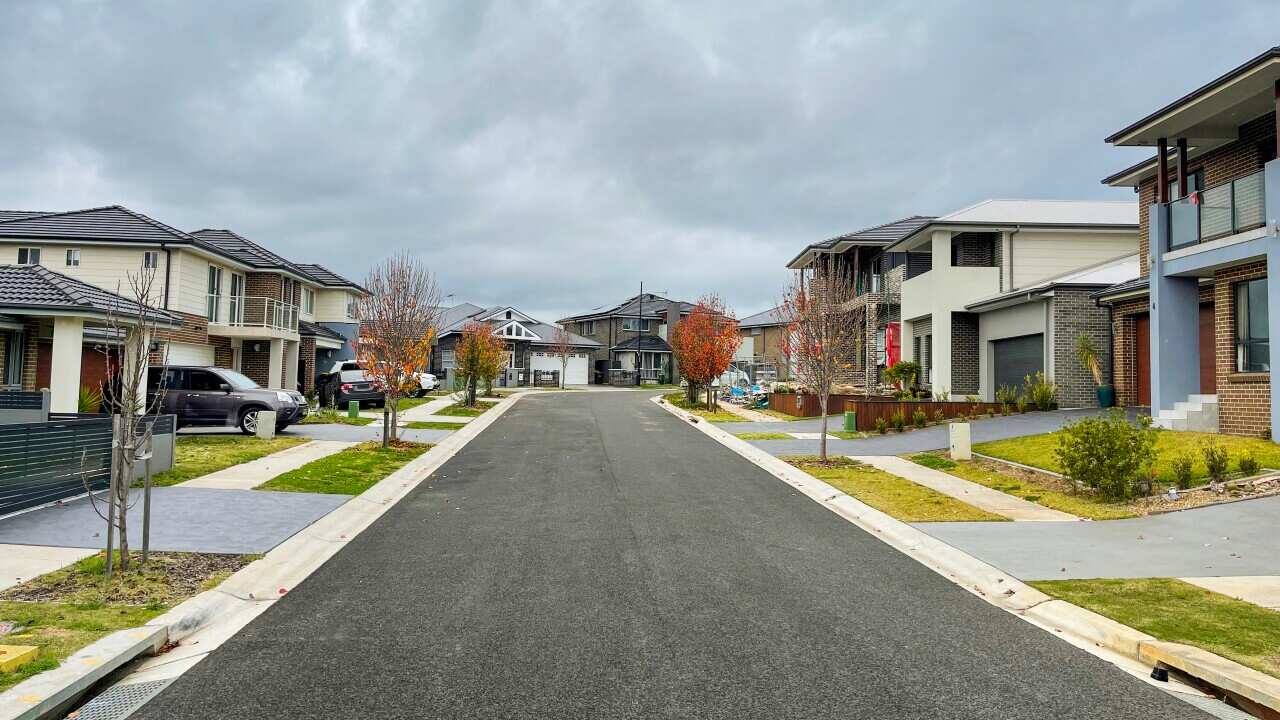 A suburban street with houses on both sides.