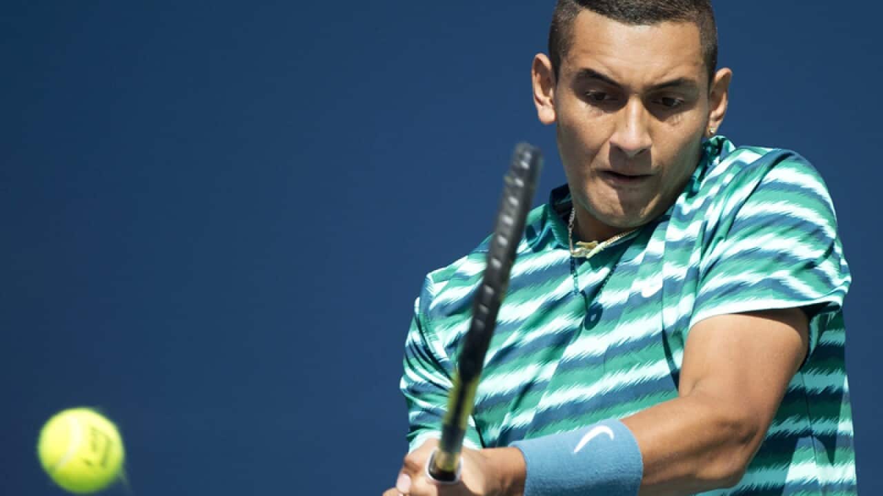 Nick Kyrgios returns the ball.