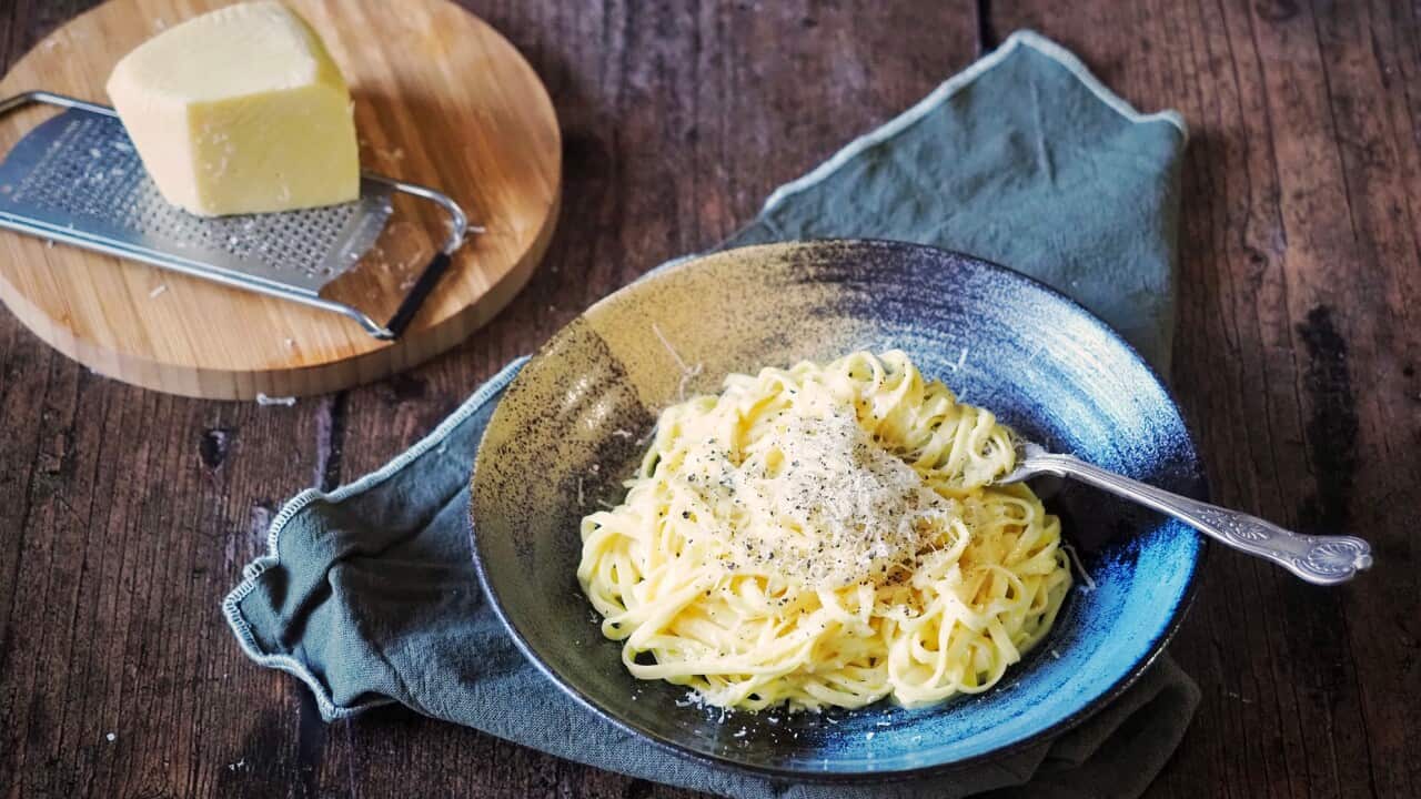 Cheesy chitarra pasta adorned simply with black pepper