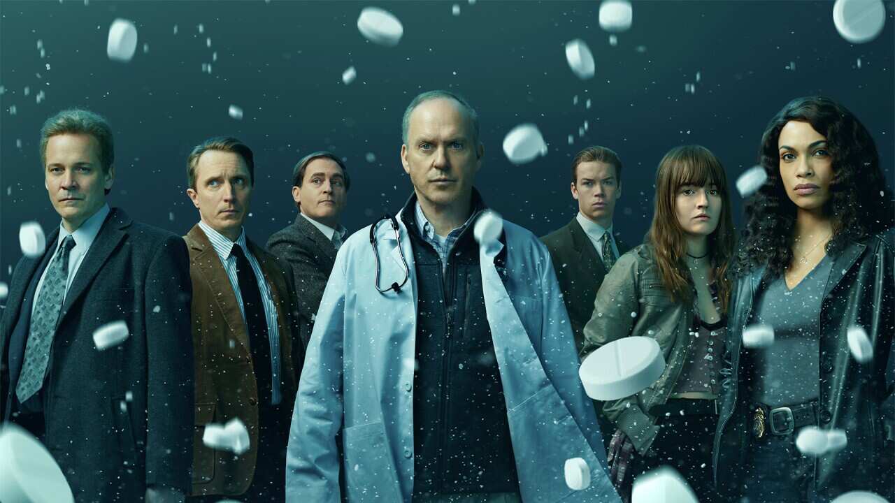 A composite graphic image shows a row of seven people, the middle one a doctor in a white coal. White tablets with the letters OC visible on some of them rain down over the image.