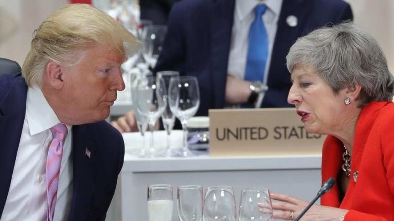 A file image of President Donald Trump and PM Theresa May