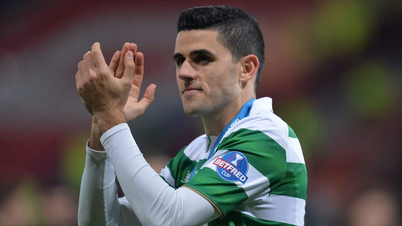 Celtic midfielder Tom Rogic applauds the fans