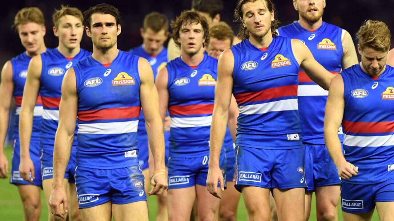 Bulldogs players leave the ground after the Round 13 AFL
