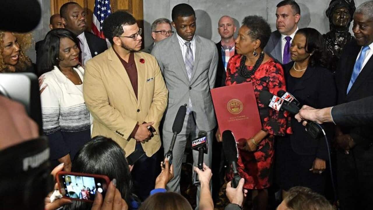 James Shaw Jr. is surrounded by family at a press conference.