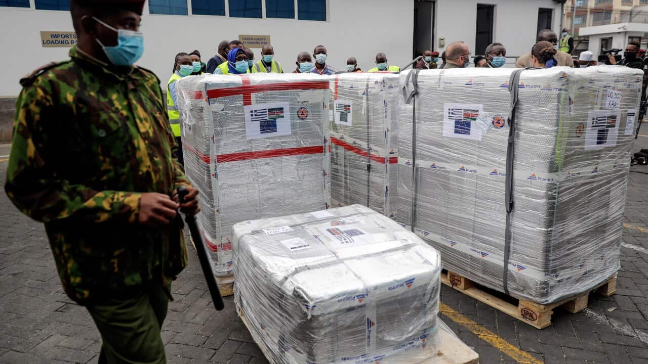 A Kenyan soldier guards a consignment of 182,000 AstraZeneca.