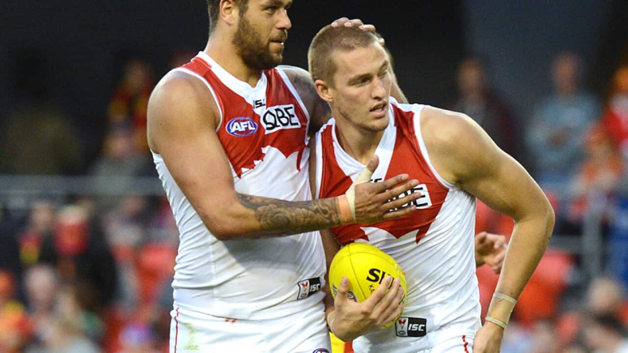 Swans player Lance Franklin (left) reacts with Sam Ried