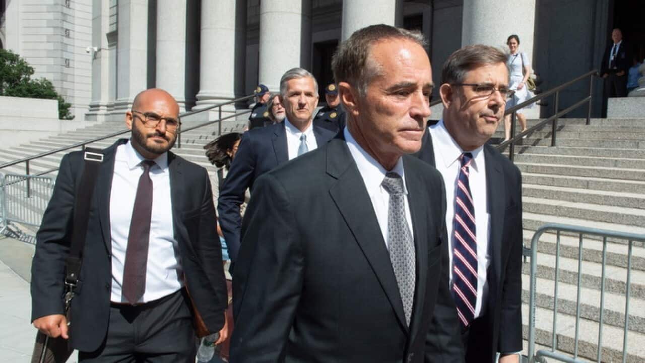 US Republican Congressman Chris Collins (C) leaves a Federal Court in New York after being charged with insider trading.
