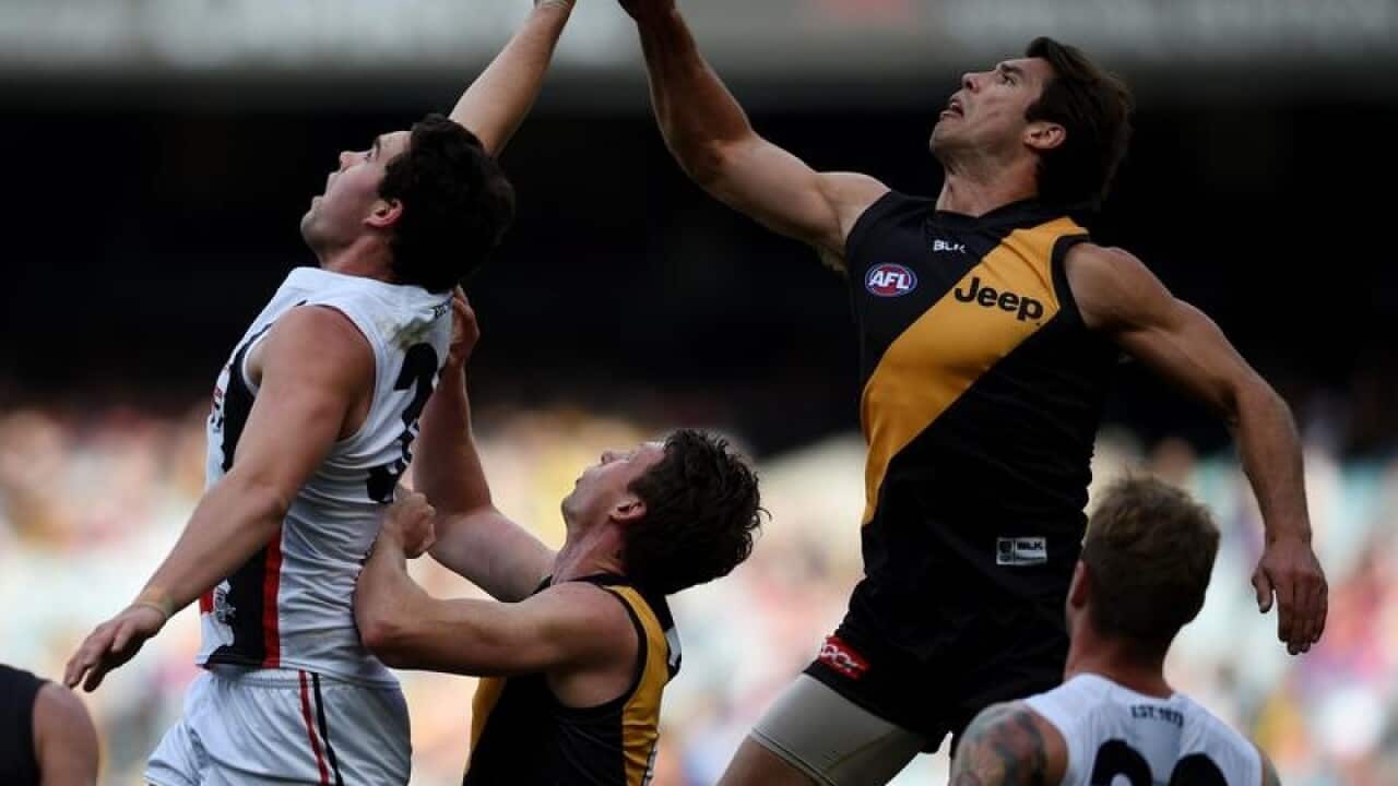 St Kilda and Richmond players jump for a mark