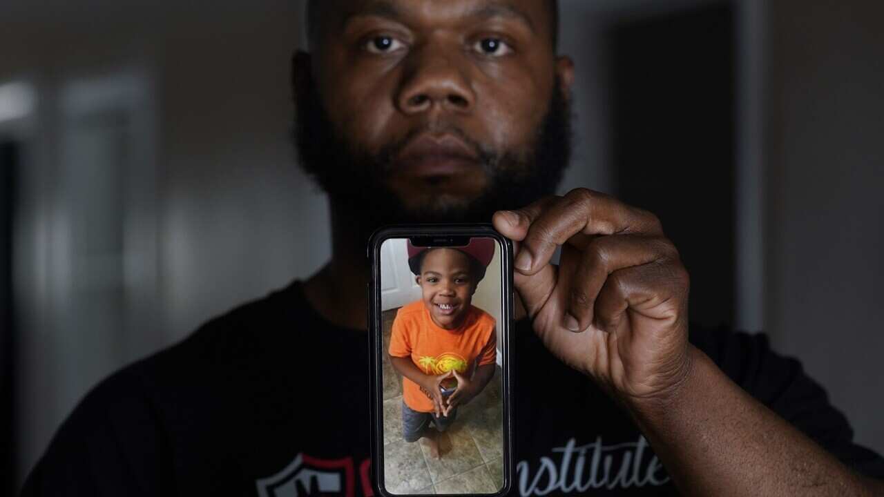 Leon Abdullah El-Alamin shows a photo of his son Leon Jr