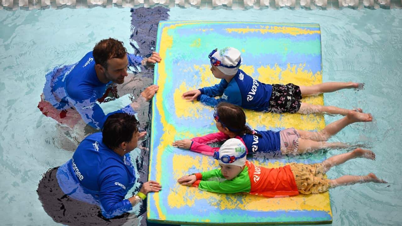 Children take part in a swimming lesson