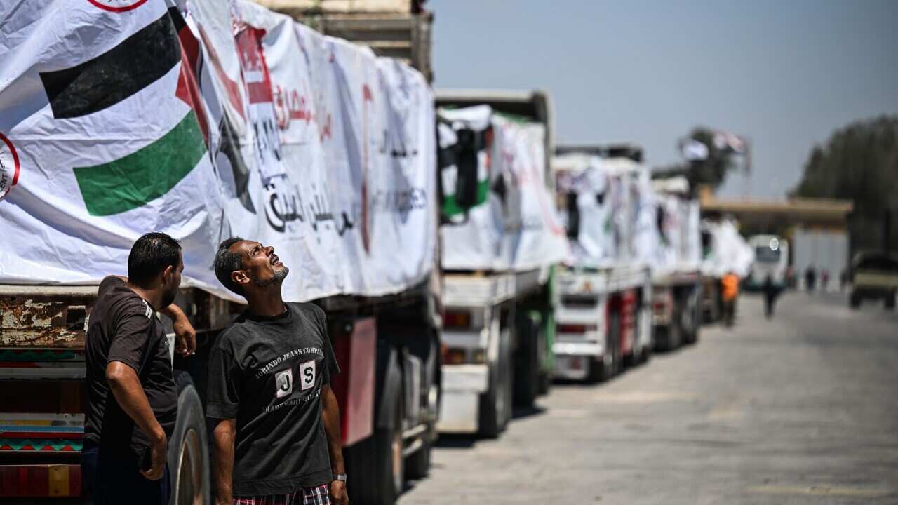 Trucks with humanitarian aid wait at Rafah border