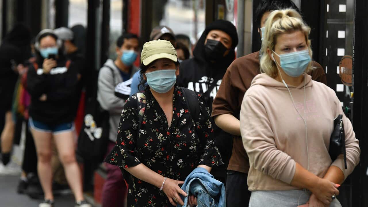 People queue at a walk-in COVID-19 testing site in Melbourne.