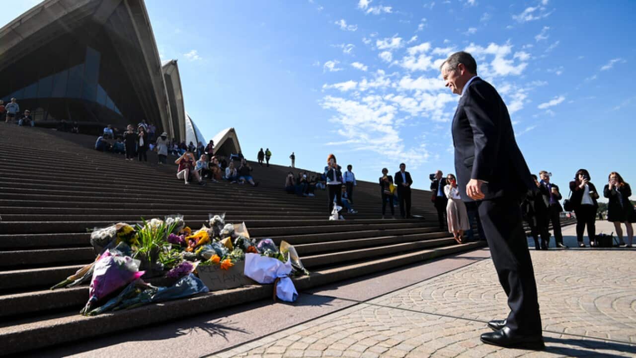 Opposition Leader Bill Shorten in front of the Opera House placing a floral tribute to the late former Australian Prime Minister Bob Hawke.