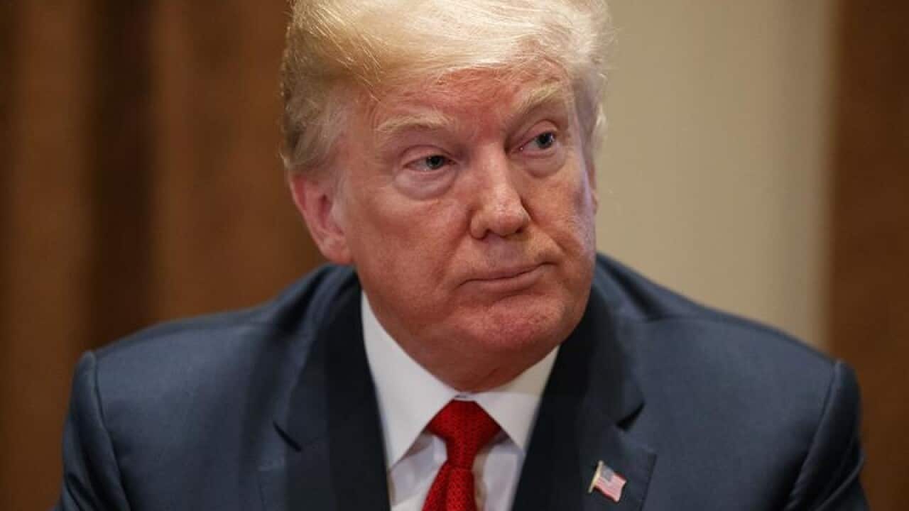 US President Donald Trump listens during a meeting at the White House.