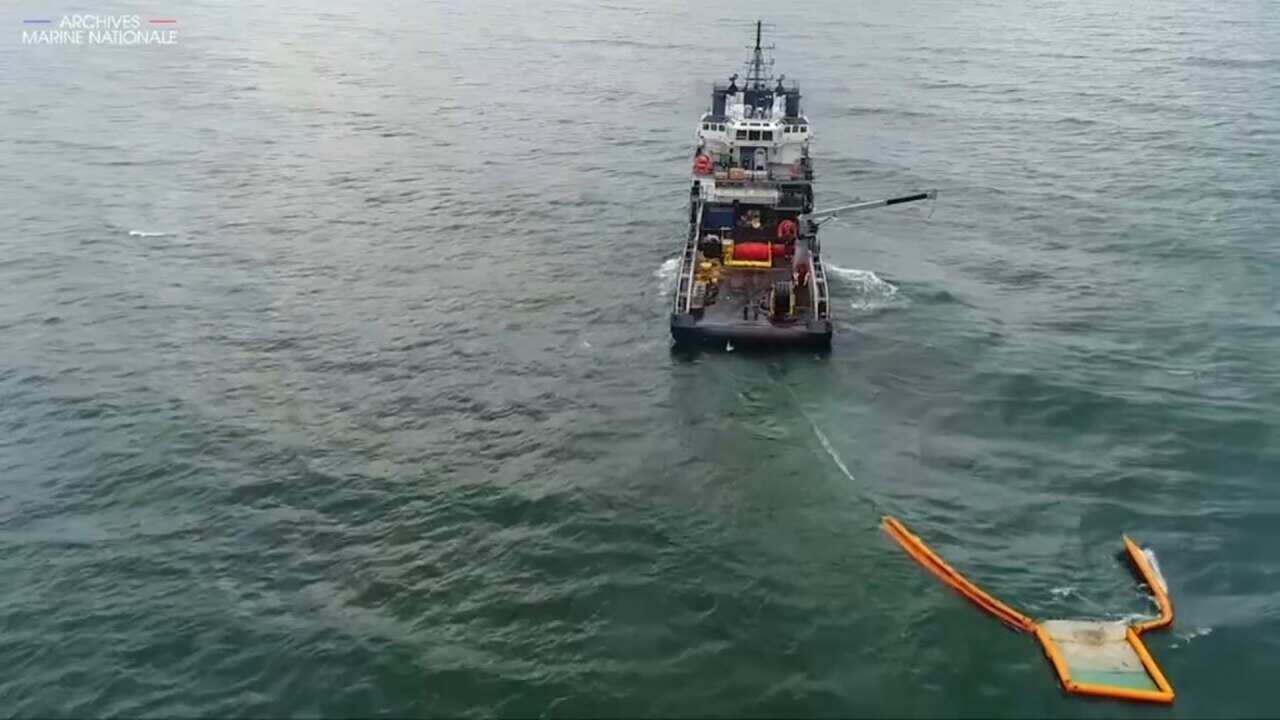 French authorities work to contain oil spill.