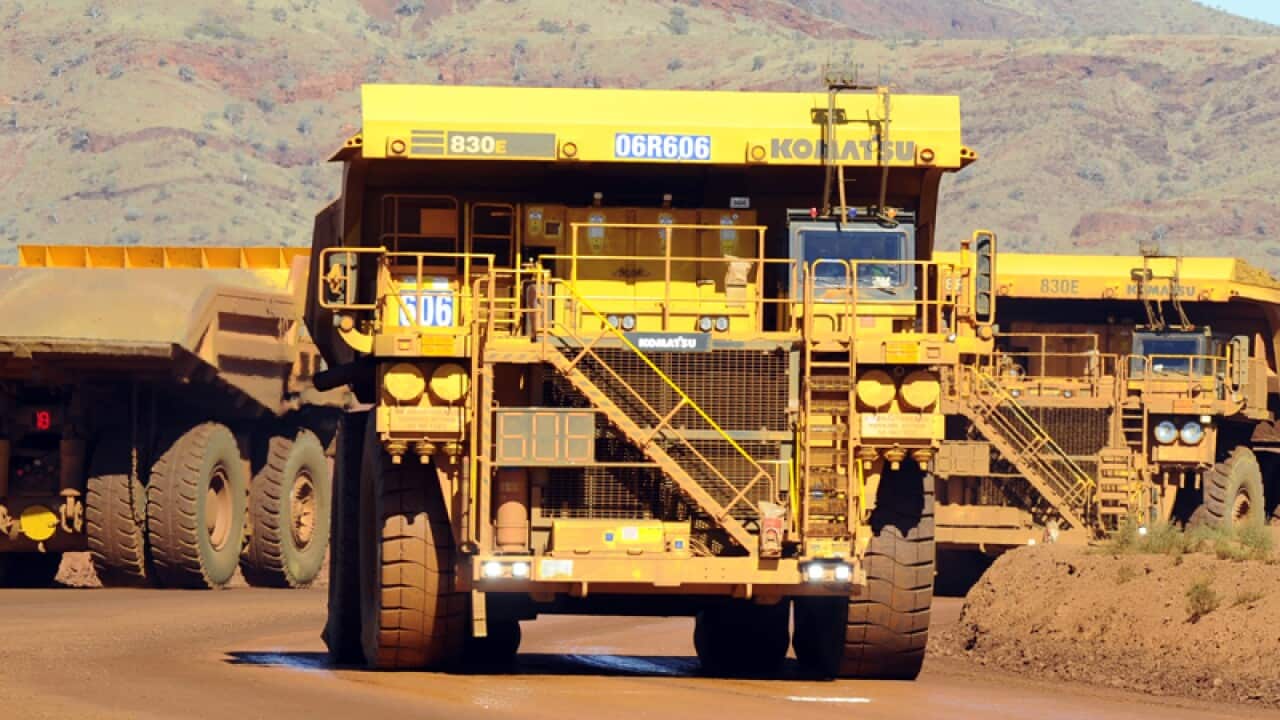 Haulage trucks at a Rio Tinto iron ore mine