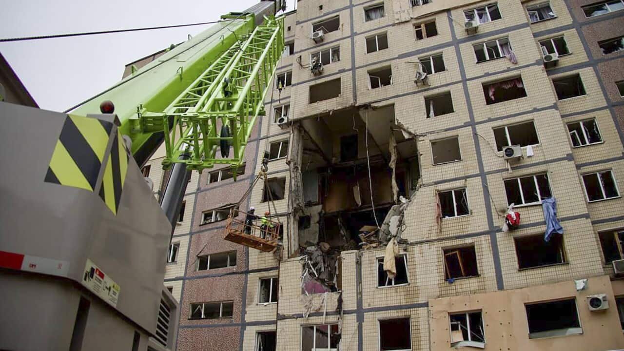 Ukrainian rescuers working at the site of a Russian strike on a residential building in Dnipro, central Ukraine, 08 November 2025