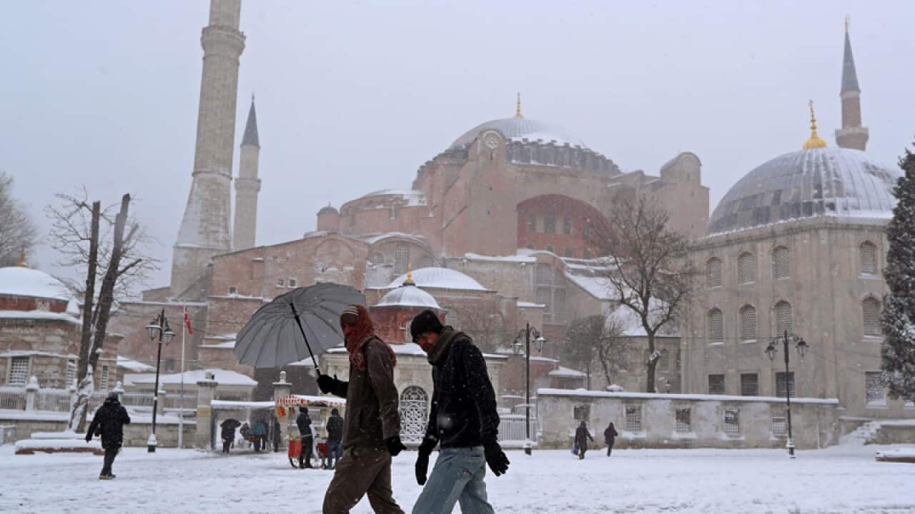 People walk in front of Hagia Sophia Museum in Istanbul