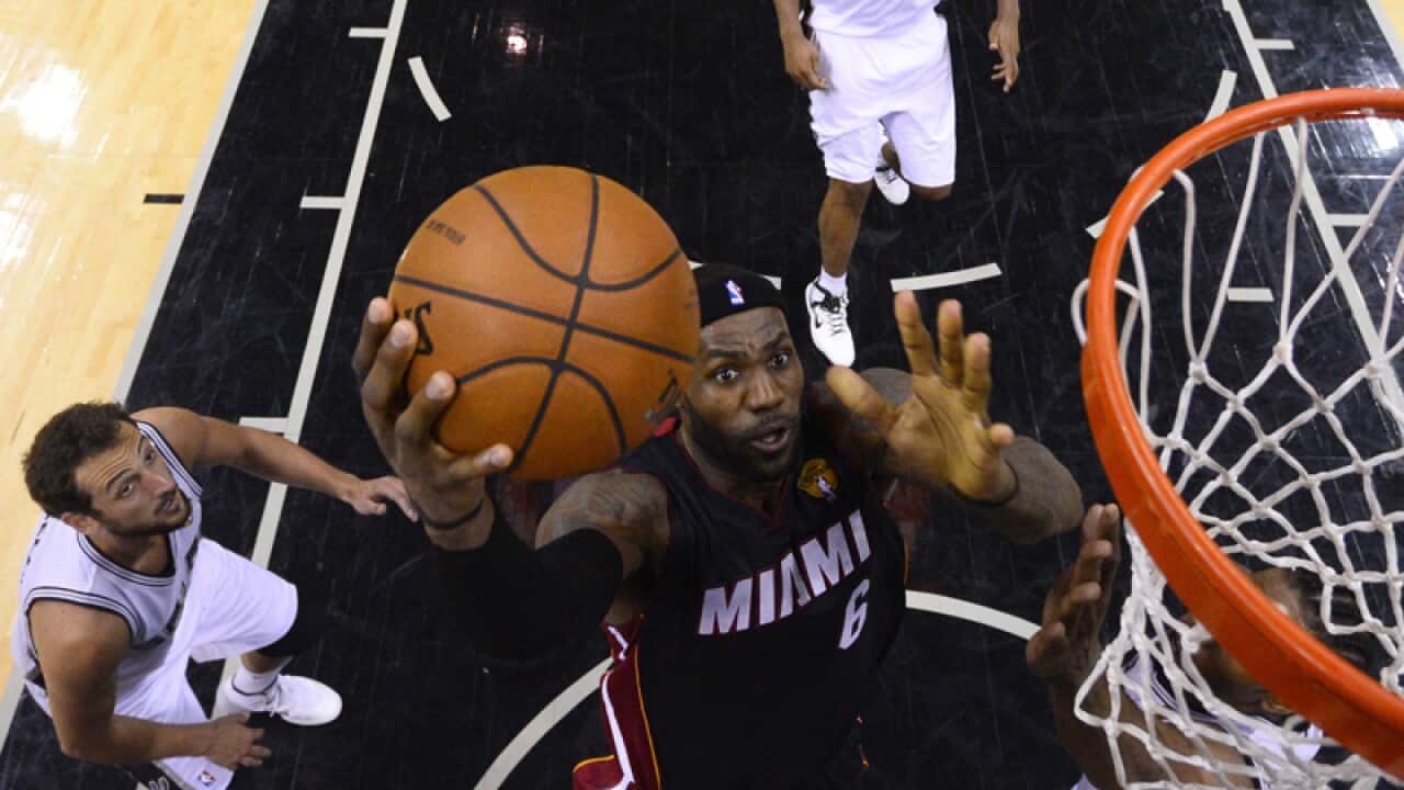 Miami Heat forward LeBron James (C) scores agains San Antonio Spurs