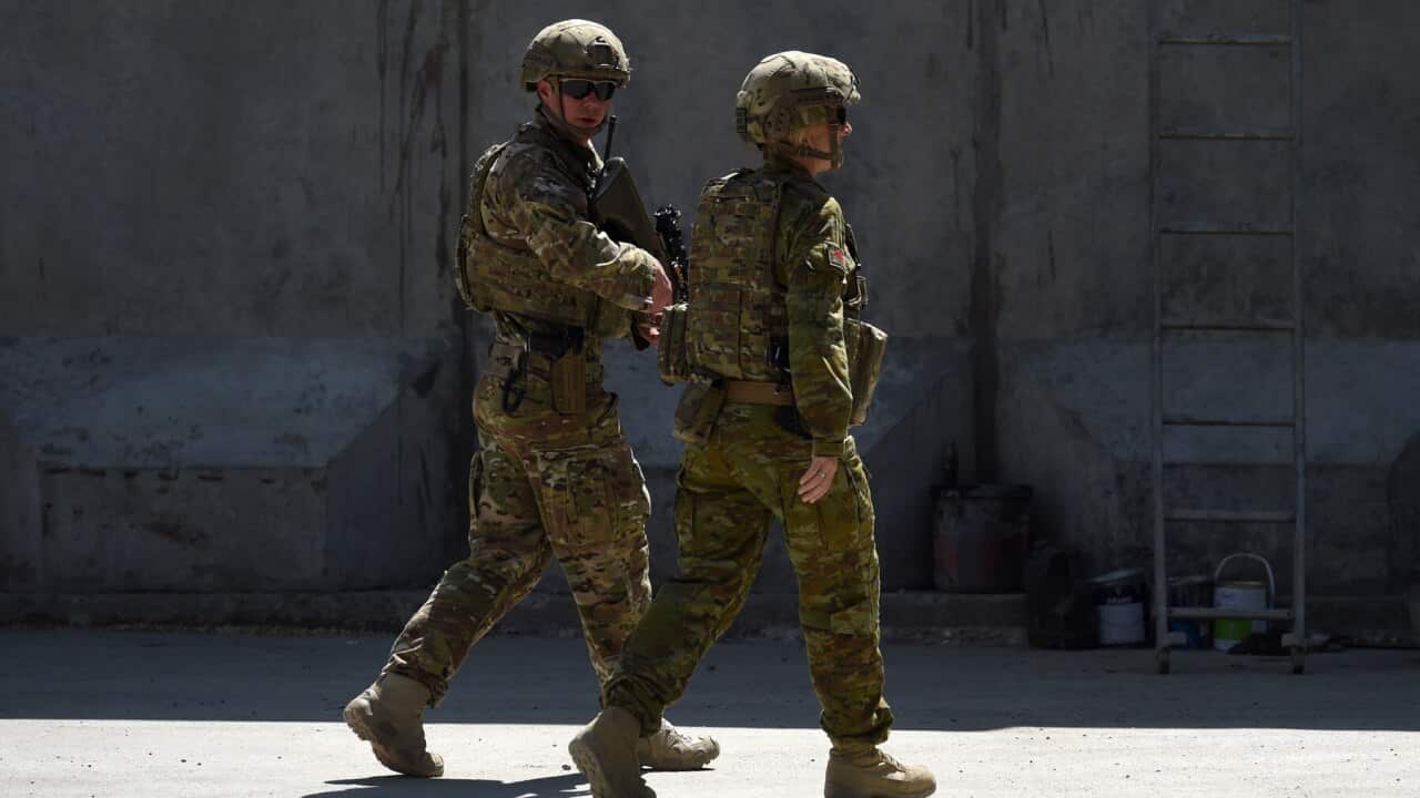 Australian Defence Force members walk through the Green Zone in Kabul, Afghanistan