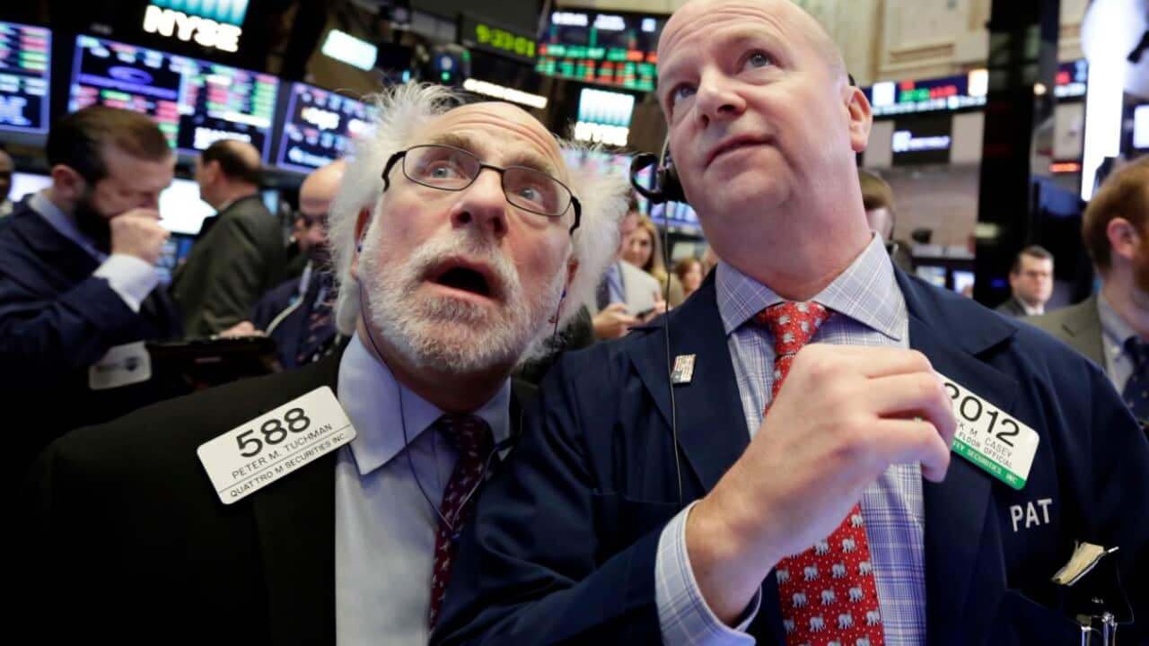 Traders Peter Tuchman, left, and Patrick Casey work on the floor of the New York Stock Exchange, Thursday, Feb. 8, 2018. 