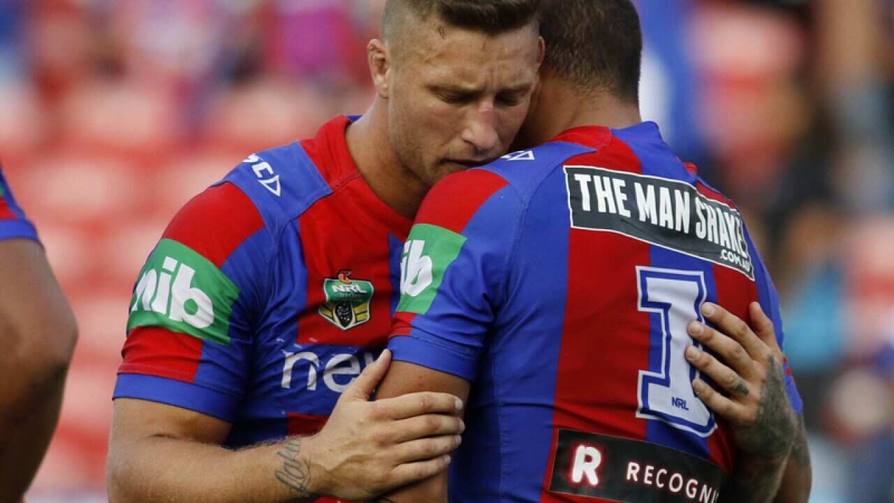 Newcastle players Tariq Sims (L) and Dane Gagai console each other