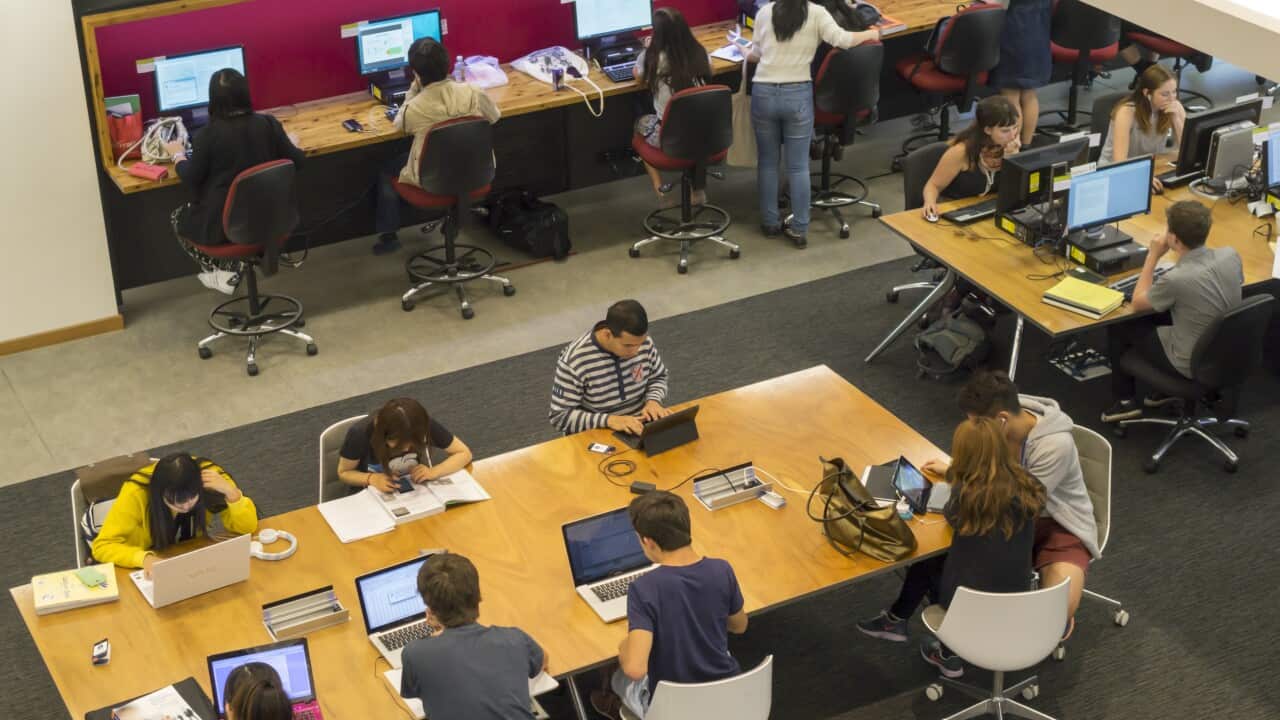 Australia, Carlton Parkville University of Melbourne Baillieu Library studying laptop computer overhead view