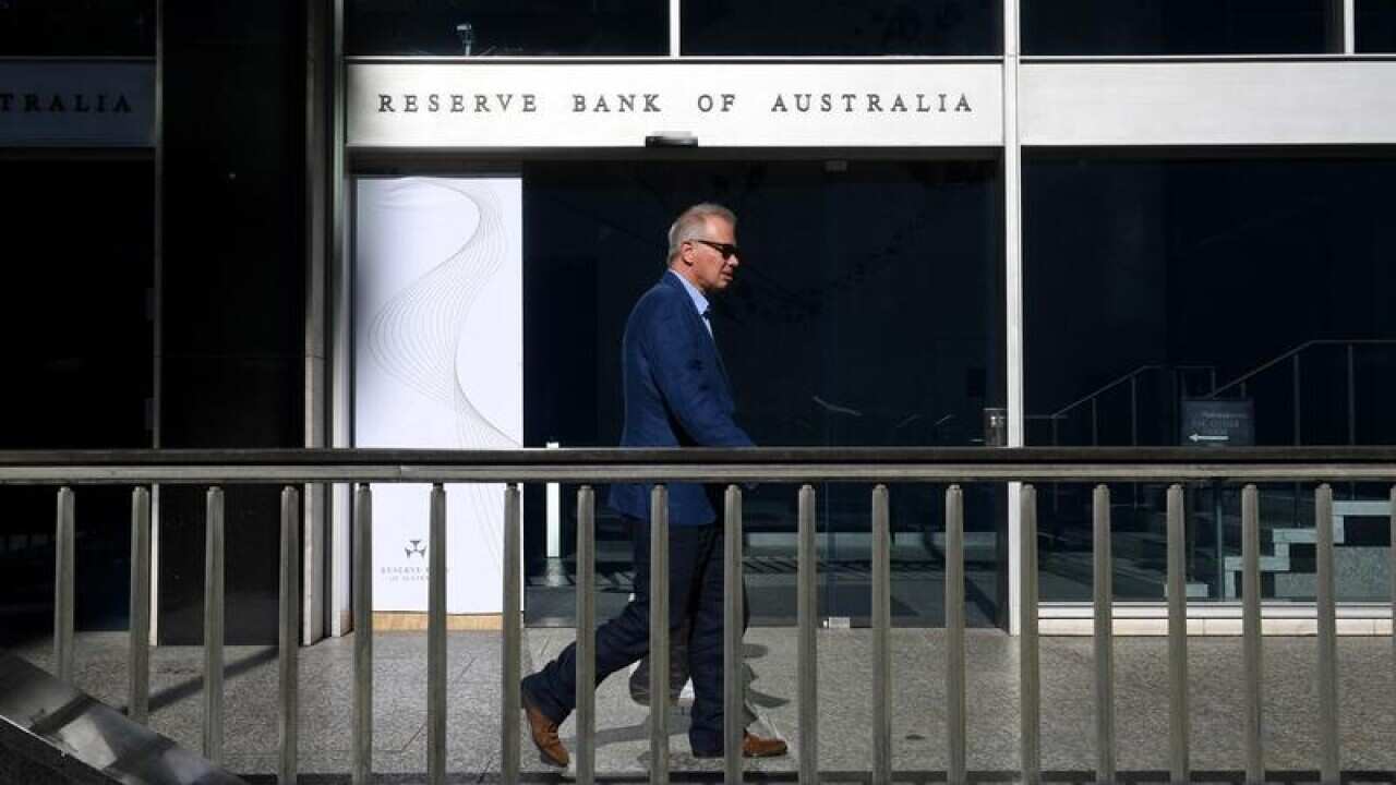 A man walks past the Reserve Bank of Australia