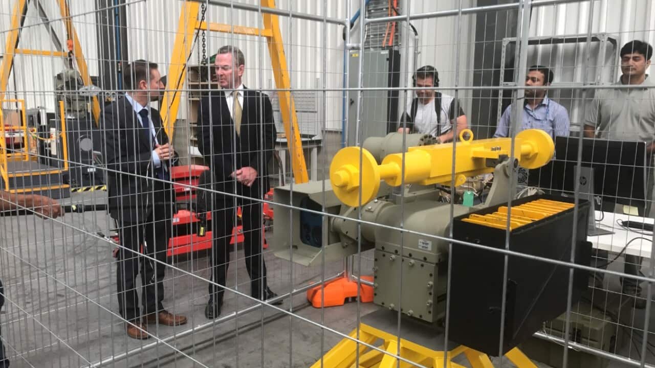 Defence Industry Minster Christopher Pyne inspects a remote weapons system at Electro Optic Systems, a Canberra defence company, in Canberra, Tuesday, January 30, 2018. 