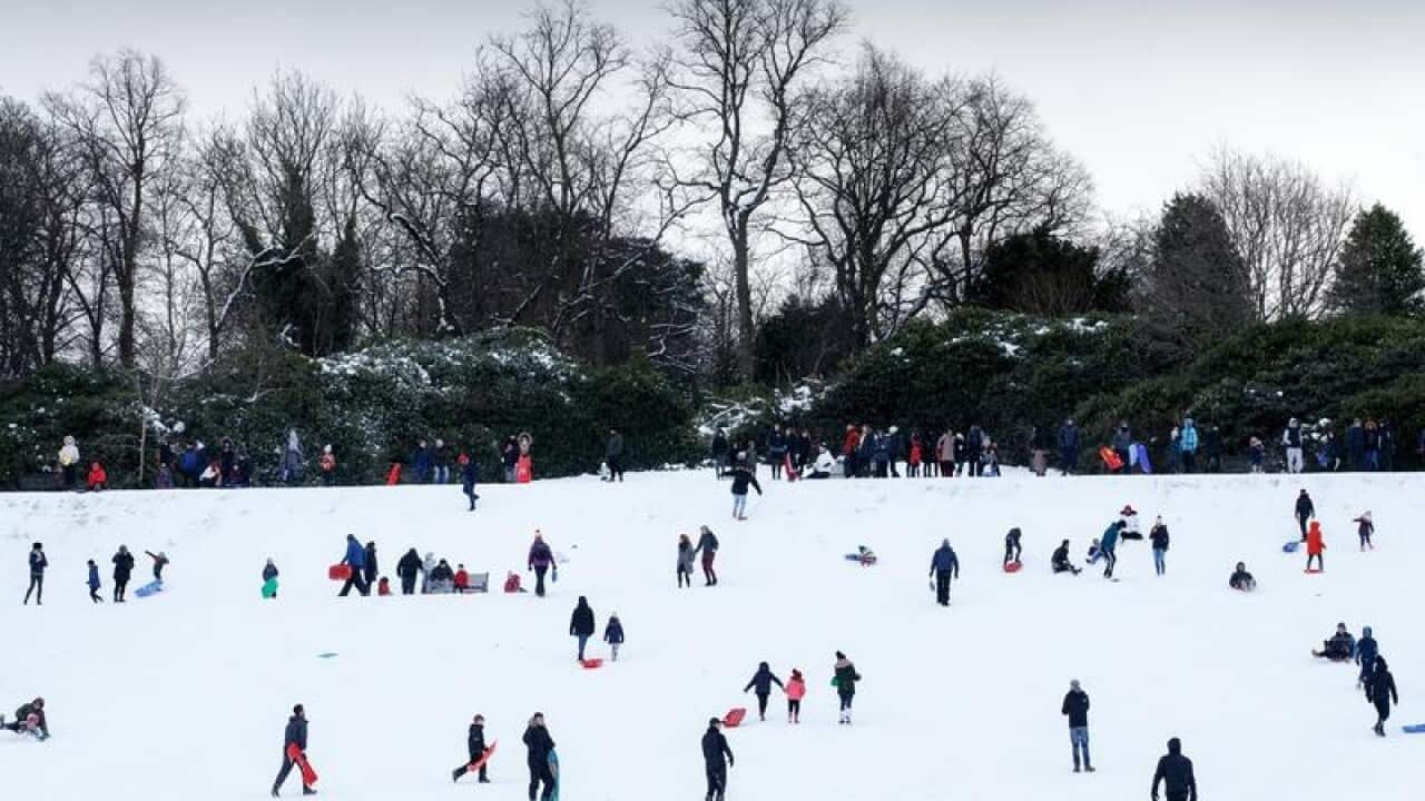 People enjoy having fun in the snow in Queens Park, Glasgow,