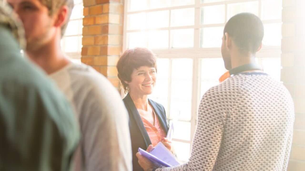 Man and woman talking at window in community center
