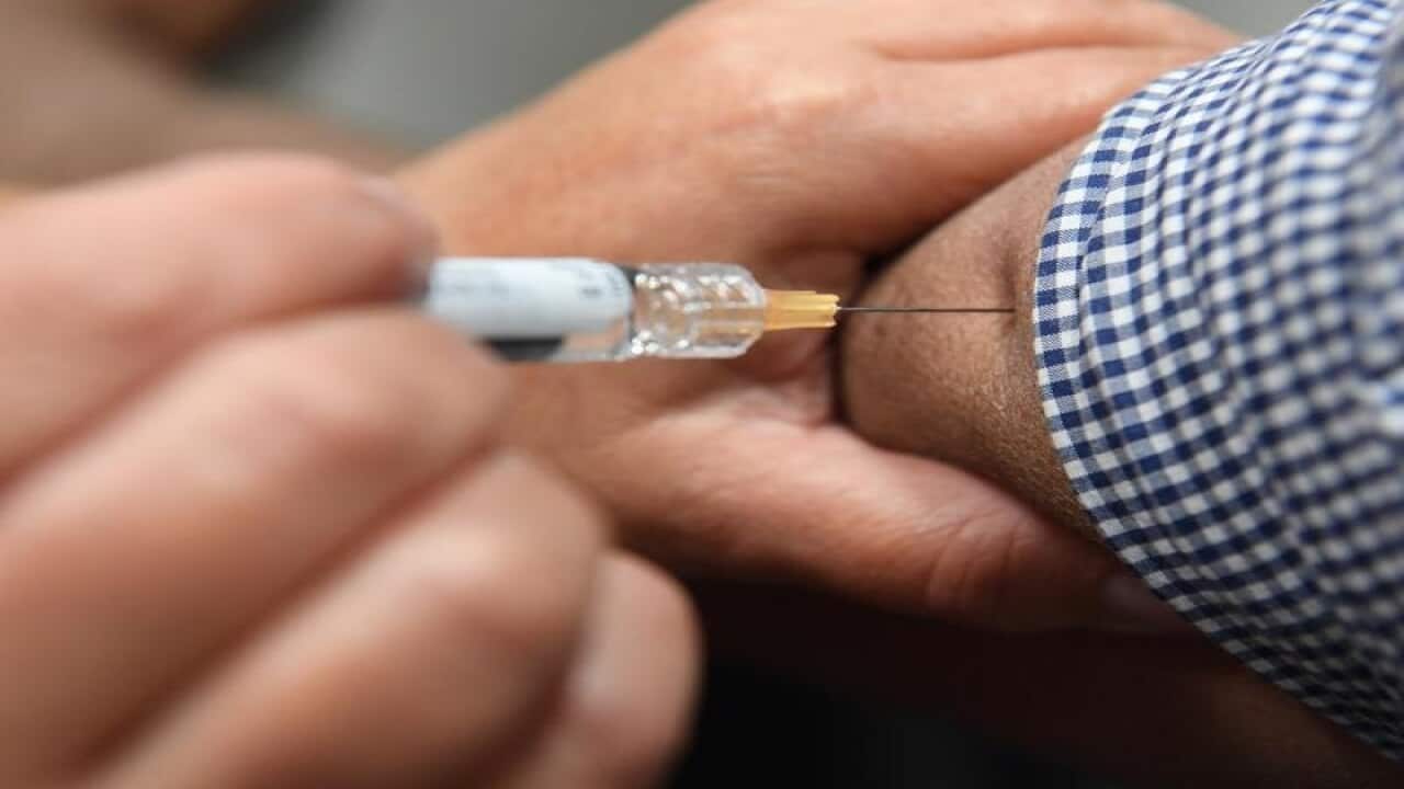 A man receiving a flu immunisation shot
